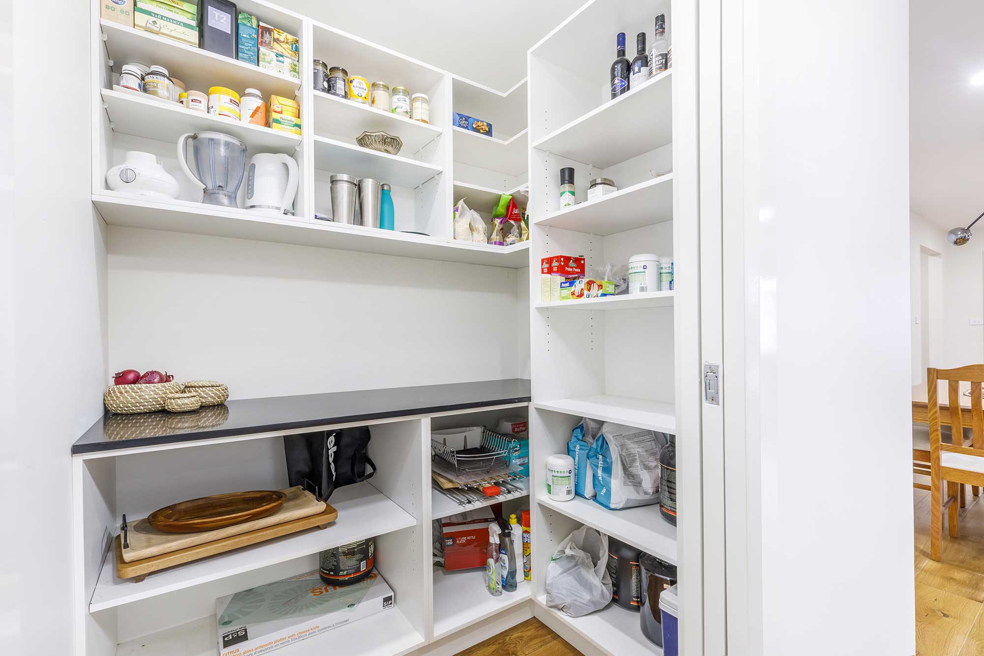 Kitchen pantry with custom shelving and storage inside a Taylor, Canberra custom home built by CanDo House.