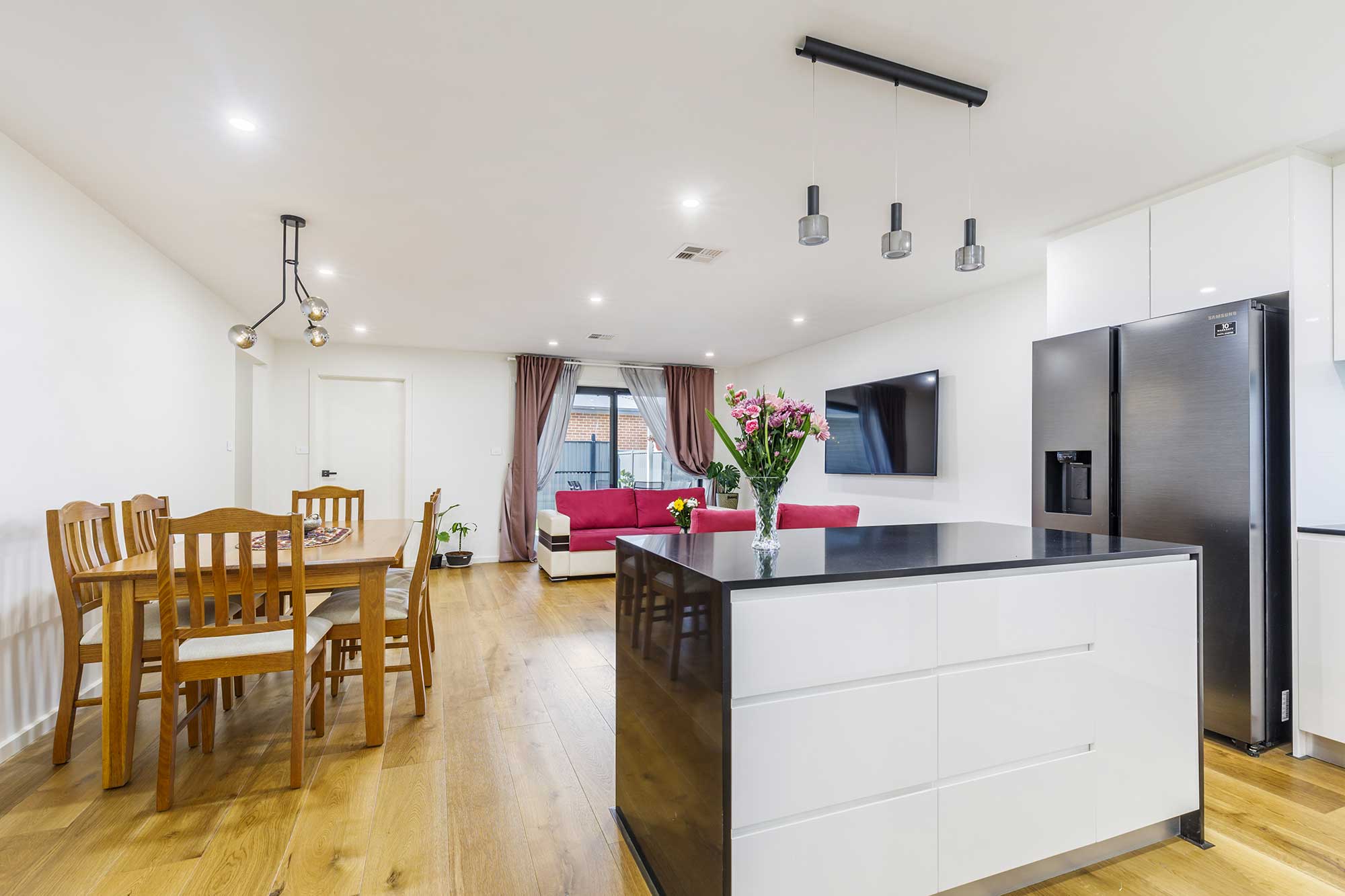 Open-plan kitchen, dining and living area in a custom home build in Taylor, Canberra, designed and completed by CanDo House with modern finishes.