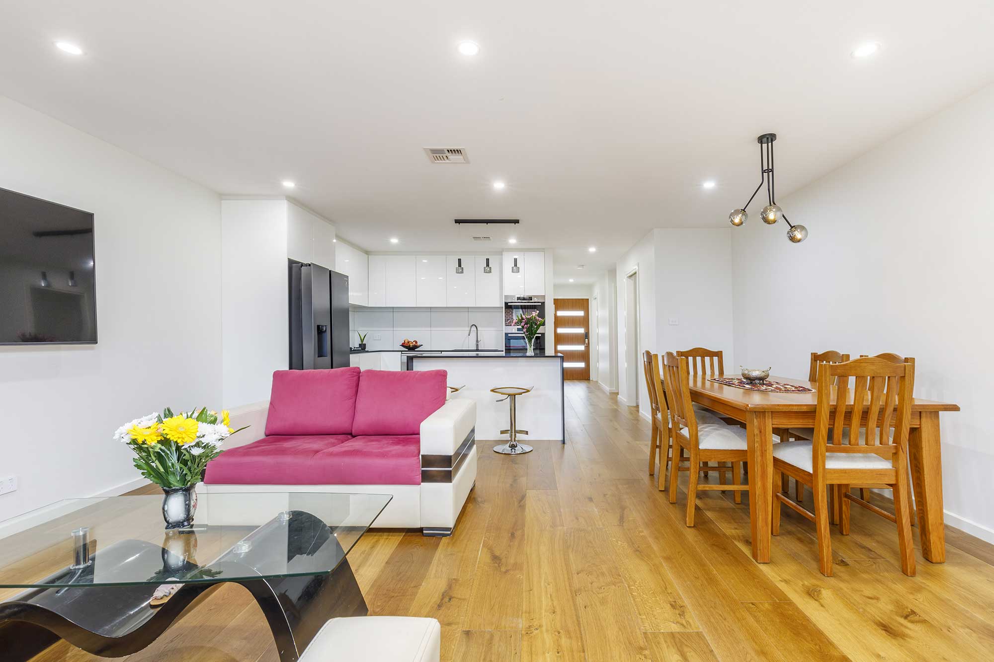 Open-plan living and dining area in a custom home build in Taylor, Canberra, completed by CanDo House with modern finishes and timber flooring.