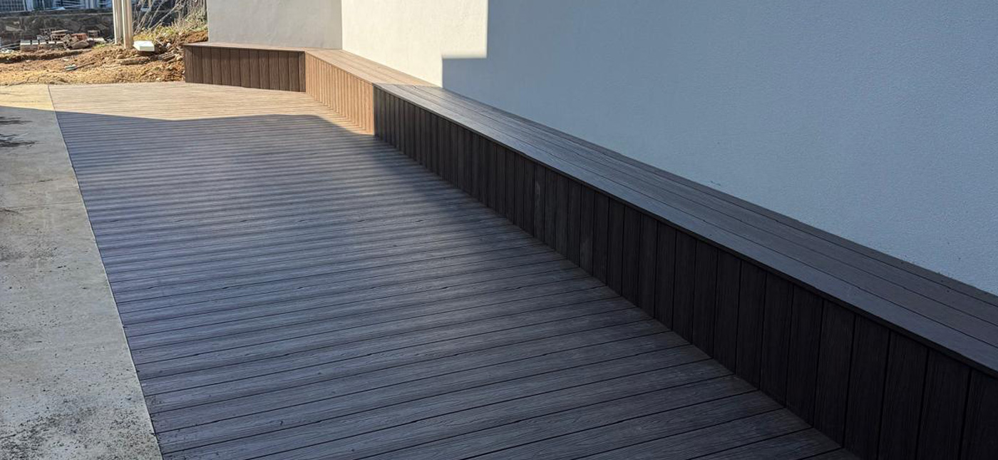 Composite decking installed by CanDo House in Canberra, featuring modern outdoor bench seating and durable low-maintenance materials.