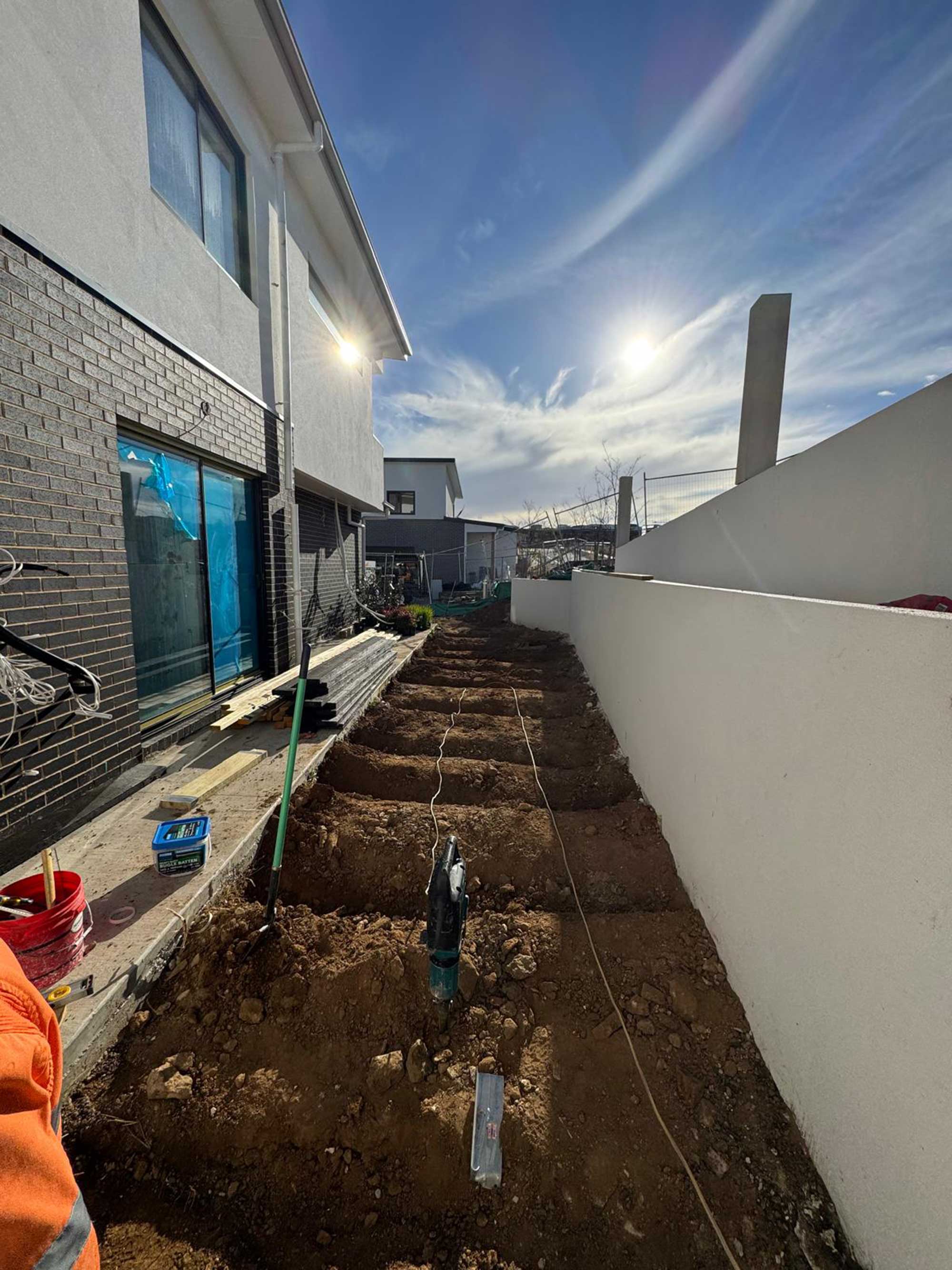 Newly installed composite walkway decking along boundary wall in Whitlam Canberra