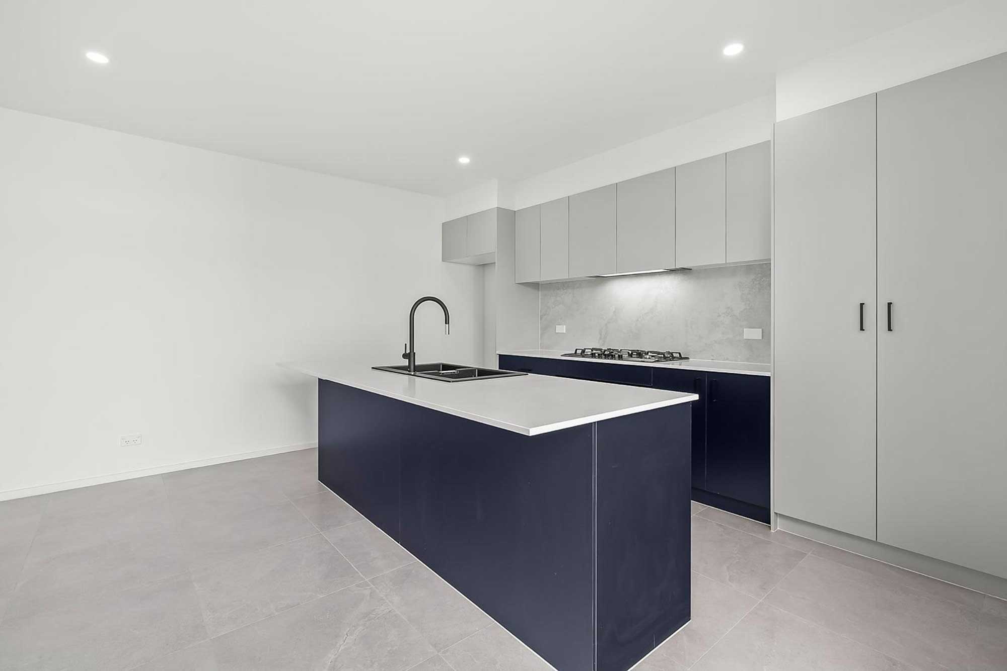 Modern kitchen renovation with custom cabinetry and matte black fixtures in Whitlam Canberra