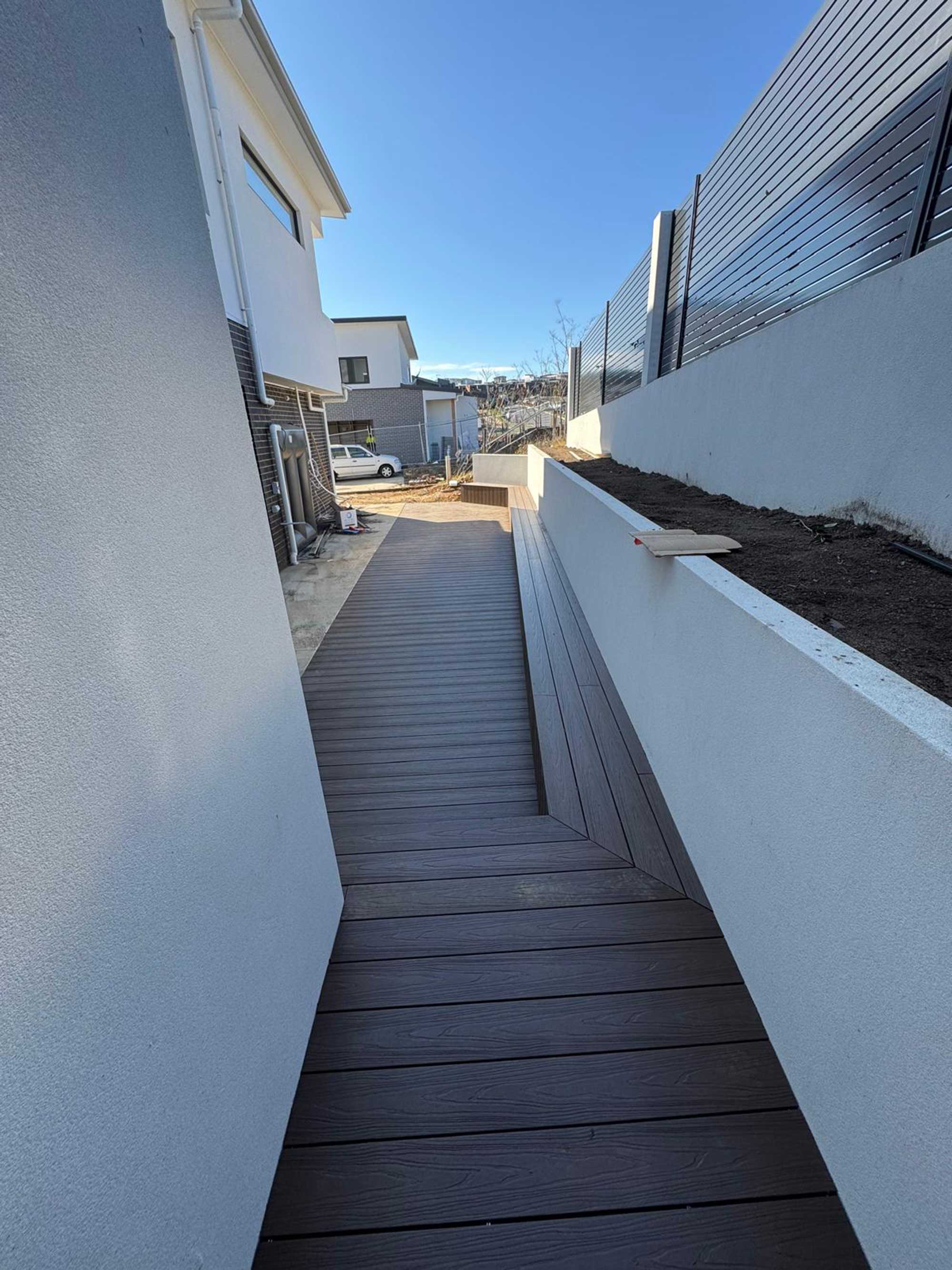 Modern balcony composite deck with integrated seating in Whitlam Canberra