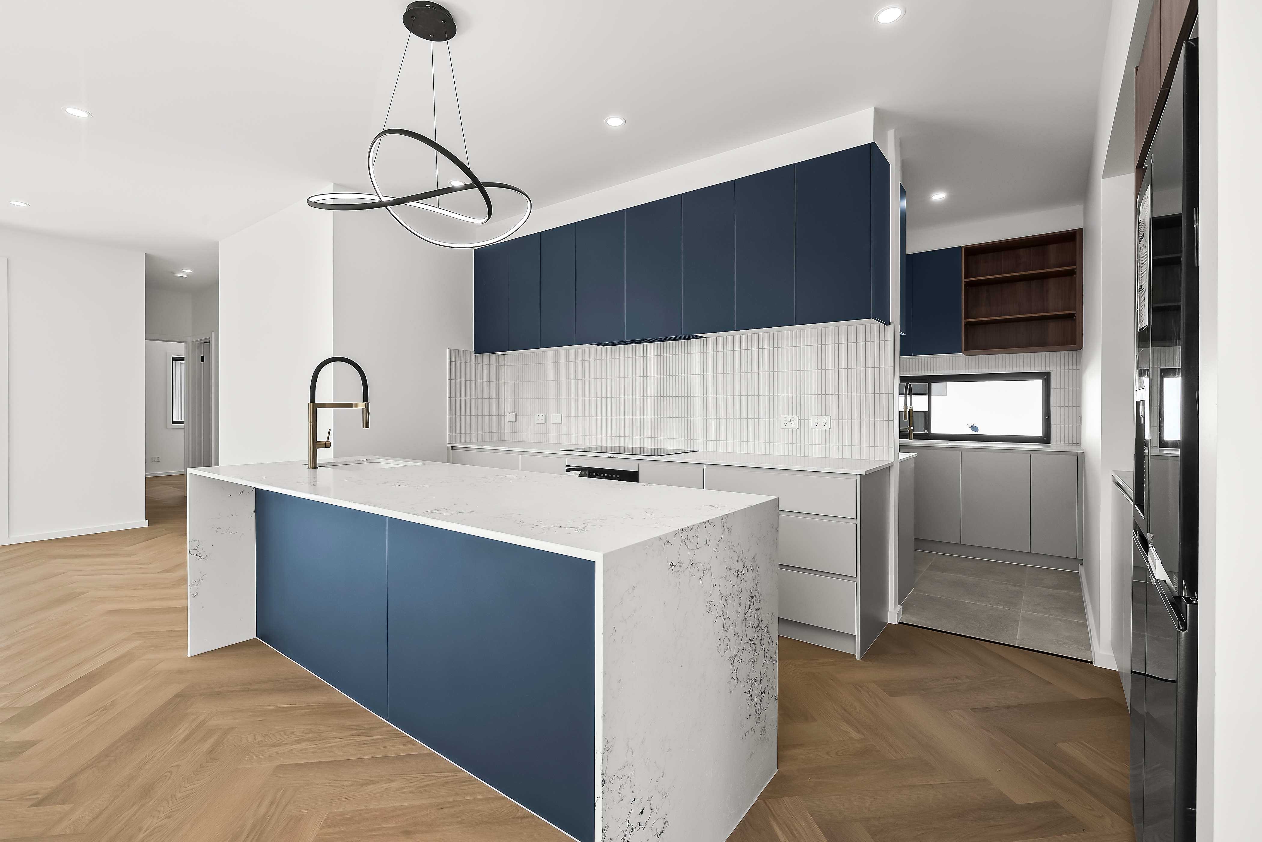 Modern kitchen renovation with custom cabinetry and matte black fixtures in Whitlam Canberra