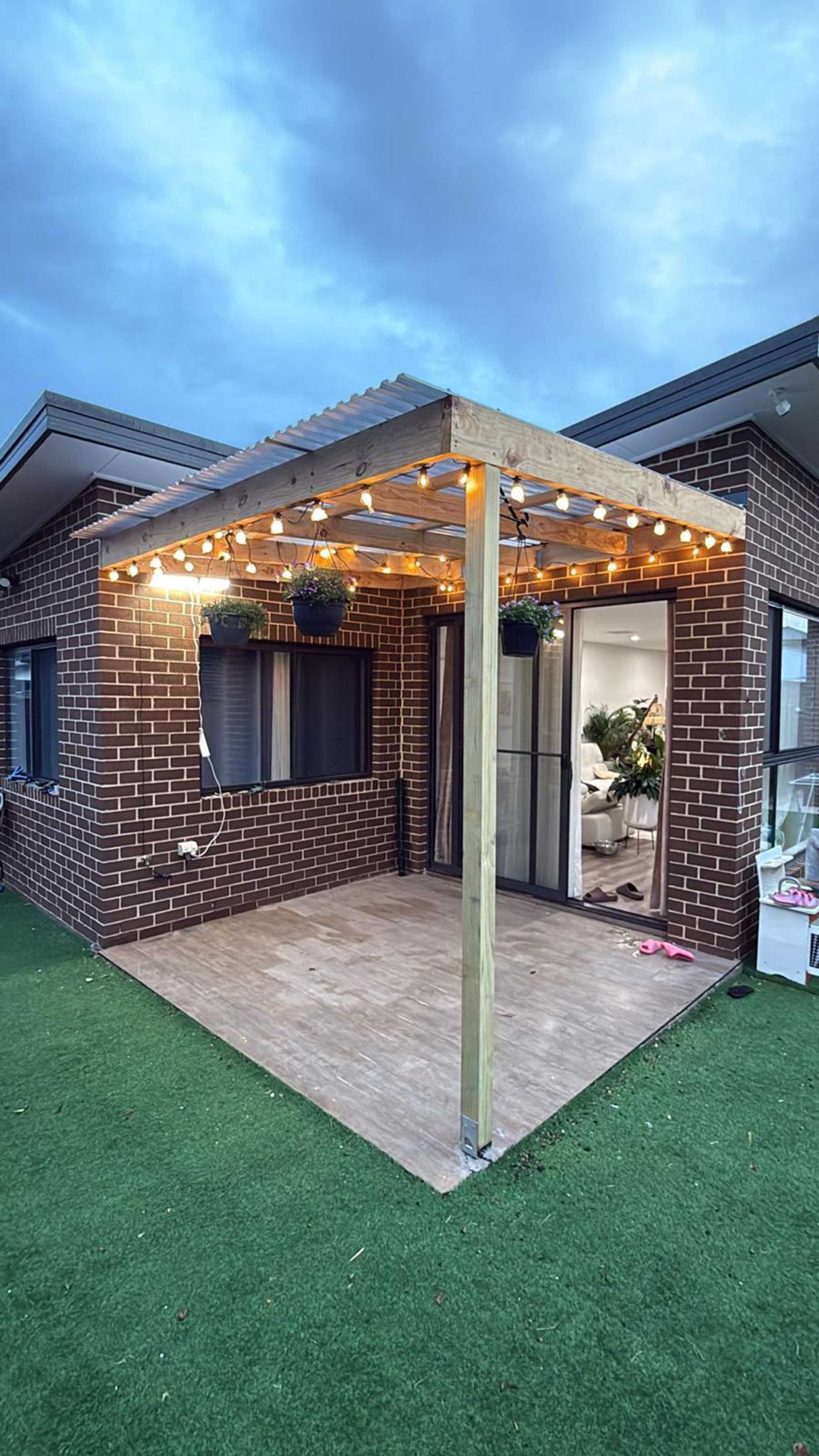 Timber pergola with warm string lights installed in Taylor, Canberra